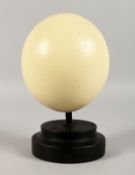AN OSTRICH EGG ON A STAND. 6ins long.