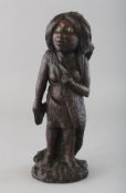 A POLYNESIAN CARVED WOOD STANDING FEMALE FIGURE with mother-of-pearl eyes. 10ins high.