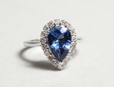 A SUPERB 18CT WHITE GOLD, PEAR SHAPED SAPPHIRE AND DIAMOND RING. Sapphire: 4cts. Diamonds: 0.85cts.