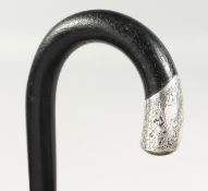 A WALKING STICK with silver tip. 3ft long.