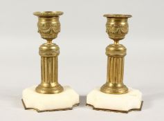 A SMALL PAIR OF ORMOLU AND MARBLE CANDLESTICKS. 5ins high.