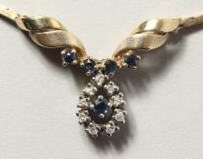 A 9CT GOLD NECKLACE with sapphire and diamond pendant.