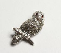 A SILVER OWL BROOCH.