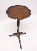 A GEORGIAN MAHOGANY TALL TRIPOD TABLE, with piecrust top, turned column and curving legs with claw