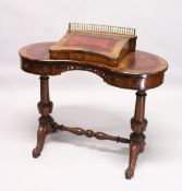 A VICTORIAN WALNUT KIDNEY SHAPED WRITING DESK, with rising writing surface and fitted interior,