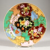 A 19TH CENTURY FRENCH PORCELAIN PLATE in brilliant colours, painted with flowers. 9ins diameter.