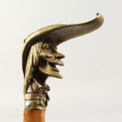 A 19TH CENTURY CONTINENTAL CAST BRONZE HANDLED WALKING STICK with head of a joker. 2ft 9ins long.