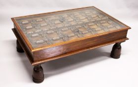 AN EARLY 17TH - 18TH CENTURY DOOR PANEL with iron mounts and rings converted into a coffee table.