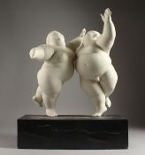 A LARGE WHITE BISQUE GROUP OF TWO DANCING FAT PEOPLE. 16ins high on a wooden base.