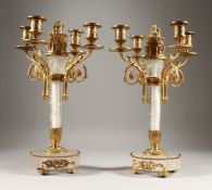 A VERY GOOD PAIR OF CRYSTAL AND ORMOLU FOUR-BRANCH CANDELABRA on circular bases. 15ins high.