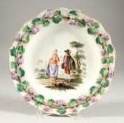 AN UNUSUAL VIENNA PORCELAIN PLATE, with raised border of fruiting vines, the centre painted with a