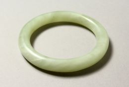 A JADE BANGLE. 8cm diameter. 58mm internal diameter.