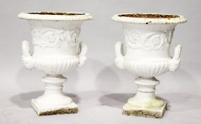 A PAIR OF WHITE PAINTED CAST IRON CAMPAGNA URNS. 2ft high.
