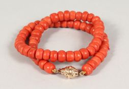 A SUPERB LARGE CORAL SINGLE STRAND NECKLACE with 18ct gold clasp. 16ins long. 72gms.