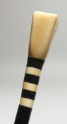 A WALKING CANE with IVORY HANDLE, ART DECO DESIGN. 2ft 9ins long.