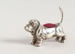 A SILVER BASSET DOG PIN CUSHION.
