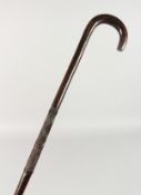 A NATIVE WALKING STICK with crosshatch carving. 3ft 3ins long.