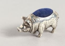 A SILVER PIG PIN CUSHION.