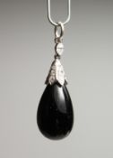 AN ONYX AND DIAMOND PENDANT.