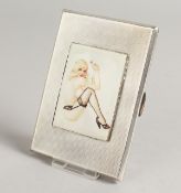 A GEORGE VI ENGINE TURNED SILVER CIGARETTE CASE, the top with an enamel of a nude in stockings.