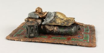 A PAINTED COLD CAST SLEEPING NUDE on a carpet. 6ins long.