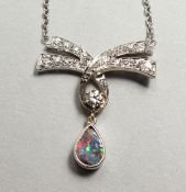 A VERY GOOD DIAMOND BOW PENDANT on a chain.