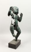 AN UNUSUAL BRONZE FIGURE OF A BABY, standing on one leg, crying, on a plinth base. 23ins high.