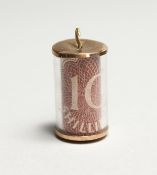 A TEN SHILLING NOTE PENDANT.