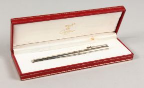 A CARTIER SILVER PEN in a box.