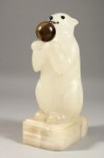 A CARVED ALABASTER POLAR BEAR LAMP. 9.5ins high.