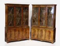 A PAIR OF GEORGIAN STYLE MAHOGANY STANDING BOOKCASES, the top with three glazed doors over three