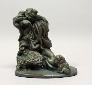 A SMALL GREEN PATINATED BRONZE GROUP, depicting an old man, a lion dog at his feet. 7ins high.