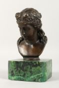 AFTER THE ANTIQUE A BRONZE FEMALE HEAD on a marble base. 4.5ins high.