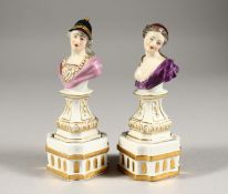A GOOD SMALL PAIR OF DRESDEN BUSTS ON FIXED STANDS of a man and woman. Crossed swords mark in
