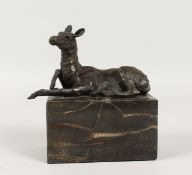 A BRONZE DEER on a marble base. 5.5ins long.