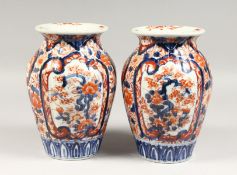 A PAIR OF IMARI JAPAN PATTERN PORCELAIN VASES. 9ins high.