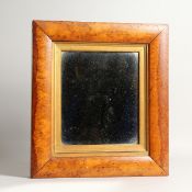 A VICTORIAN BURR CUSHION FRAMED MIRROR. 14ins x 13ins.