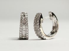 A PAIR OF 18CT WHITE GOLD TRIPLE ROW DIAMOND SET HOOP EARRINGS. Diamonds: 0.95cts.