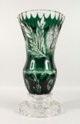 A LARGE BOHEMIAN GREEN CUT GLASS VASE on a plain circular base. 18.5ins high.
