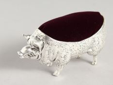 A LARGE PIG PIN CUSHION.