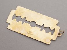 A 9CT GOLD RAZOR BLADE PENDANT. 3.2gms.