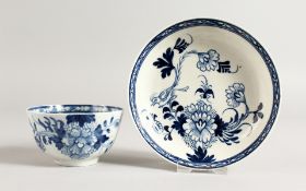 AN 18TH CENTURY LIVERPOOL BLUE AND WHITE TEA BOWL AND SAUCER with bird on a branch.