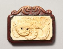 A JAPANESE CARVED WOOD AND BONE TABLET. Signed. 2.5ins.