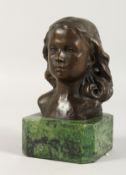 AFTER THE ANTIQUE A BRONZE FEMALE HEAD on a marble base. 4.5ins high.