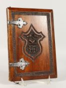 A SILVER MOUNTED WOODEN BLOTTER, carved with a crest.
