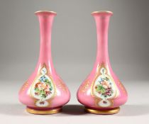 A GOOD SMALL PAIR OF 19TH CENTURY BOHEMIAN PINK GLASS VASES, each painted with three panels of