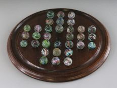 A LARGE SOLITAIRE BOARD, 11ins diameter, and marbles.