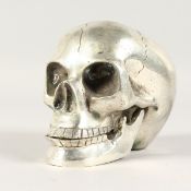 A SILVER PLATE SKULL. 4ins high.