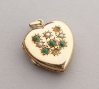 A 9CT GOLD HEART SHAPED LOCKET set with stones.