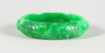 A CARVED CHINESE APPLE JADE BANGLE. 2.75ins diameter.